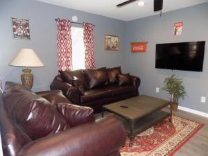 a living room with a leather couch and a coffee table at Fishing Retreat in Pensacola