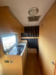 a kitchen in an rv with a stove in it at Autocarabana Ford trigano in Arrecife