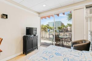 a bedroom with a bed and a view of a patio at Sunrise haven in Clearwater Beach
