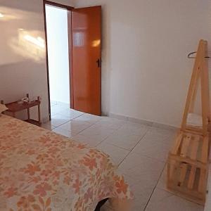 a room with a bed and a wooden ladder at Casa em João Pessoa Paraíba in João Pessoa