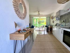 a kitchen with a table and a mirror on the wall at My Happy Place in Orient Bay in Orient Bay