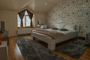 a bedroom with a large bed with a large wall at Casa Maxim - Locuință privata la poalele masivului Straja in Lupeni