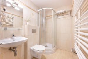 a bathroom with a toilet and a sink and a shower at Dom Wczasowy Grań in Zakopane +39 photos