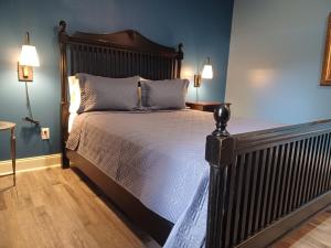 a large bed in a bedroom with blue walls at Natchez Manor Bed & Breakfast in Natchez