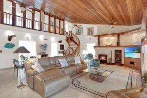 a living room with a couch and a fireplace at Sandglass 4 in Islamorada