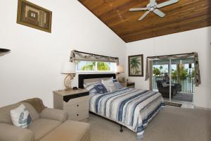 a bedroom with a bed and a couch at Sandglass 4 in Islamorada