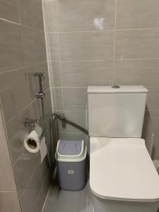 a bathroom with a toilet and a roll of toilet paper at Natoose Lodge in Saint-Louis