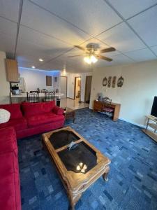 a living room with a red couch and a coffee table at Spacious Apt near Guthrie Packer in Sayre