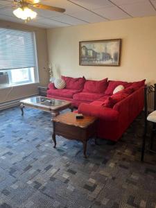 a living room with a red couch and a table at Spacious Apt near Guthrie Packer in Sayre