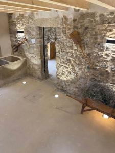 a room with a stone wall and a sink at Cal Vallverdú 2I in Preixana +14 photos