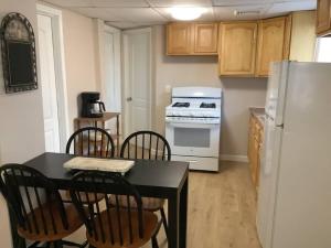 a kitchen with a table and chairs and a refrigerator at Cozy Apt near BU, Lourdes, UHS in Johnson City