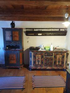 a kitchen with a wooden cabinet and two rugs at Štramberk V Kútě in Štramberk