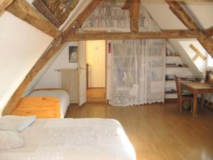 a bedroom with a bed and a desk in a attic at Grande chambre calme avec vue, wifi et parking - Le Pêchereau - FR-1-591-559 in Le Pêchereau +27 photos