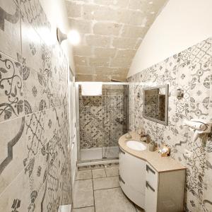 a bathroom with a sink and a shower at Mikasa in Matera