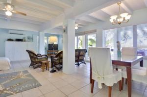 a dining room and living room with a table and chairs at Sunshine Place in Islamorada