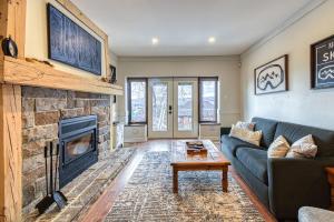 a living room with a couch and a fireplace at 124 Algonquin - Ski In Out Tremblant Mountainside Chalet in Mont-Tremblant