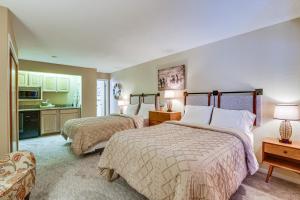 a hotel room with two beds and a kitchen at SnowDogs Breck Condo with Fireplace Walk to Lifts in Breckenridge +34 photos
