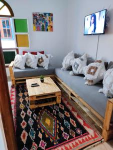 a living room with two couches and a coffee table at La casa de papel in Essaouira