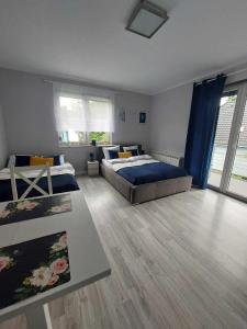a bedroom with two beds and a large window at Villa6 in Pobierowo