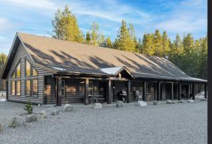 a large log cabin with a roof at The Antler Ridge Cabin in Valemount