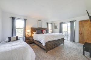 a bedroom with two beds and two windows at Groveland Home with Deck 2 Mi to Pine Mountain Lake in Groveland +30 photos