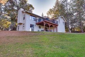 a house on top of a grassy hill at Groveland Home with Deck 2 Mi to Pine Mountain Lake in Groveland