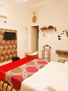 a bedroom with a large bed with a red blanket at Festina Lente in Rome