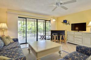 a living room with a couch and a table at Villa Riolo in Islamorada