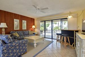 a living room with a couch and a table at Villa Riolo in Islamorada