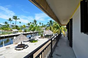 a balcony of a resort with a view of a beach at Villa Riolo in Islamorada