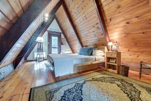 a bedroom with a bed in a wooden attic at Charming Hunter A-Frame Walk to Ski Lift! in Lanesville