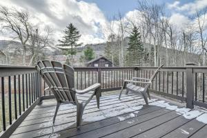 a pair of chairs sitting on a wooden deck at Charming Hunter A-Frame Walk to Ski Lift! in Lanesville
