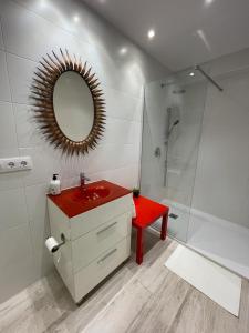 a bathroom with a red sink and a shower at Villa Sidra Gascona in Oviedo