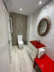 a bathroom with a toilet and a red sink at Villa Sidra Gascona in Oviedo +7 photos