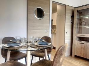 a dining room with a table and some chairs at Cap Porquerolles in Hyères