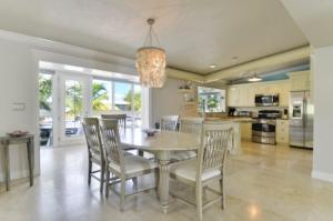 a kitchen and dining room with a table and chairs at West Plaza Del Lago in Islamorada