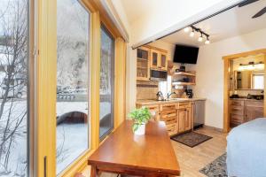 a kitchen and living room with a table and a window at Charming Studio w Kitchenette, Hot Tub Near River condo in Telluride