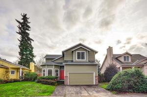 a house with a garage in a yard at Charming Beaverton Retreat about 12 Mi to Downtown! in Beaverton