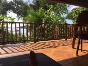 a person laying on a porch with their feet on the floor at Beautiful house on the Orla in Itacaré