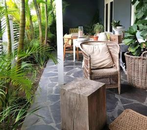 a patio with a table and chairs and plants at Concierge Hotel in Durban