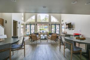 a living room with tables and chairs and a couch at Downtown San Diego Condo in Marina District! in San Diego