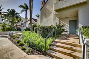 a set of stairs leading to a house with palm trees at Downtown San Diego Condo in Marina District! in San Diego