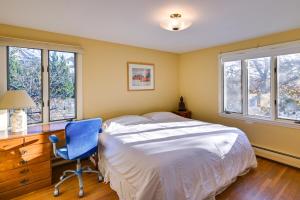 a bedroom with a bed and a desk with a blue chair at Pet-Friendly Marblehead Home Near Preston Beach! in Marblehead