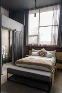 a bedroom with a large bed with a large window at Lilian Lofts Hotel & Spa in Johannesburg +138 photos