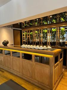 a large wooden bar with glasses on top of it at THE HOTEL in Córdoba