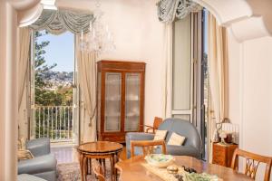 uma sala de estar com uma mesa e cadeiras e uma janela em Gemma Sea View em Nápoles