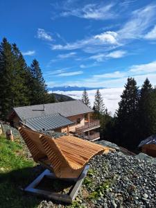 a house with a roof on a pile of rocks at Sonnenblickhütte in Klippitztorl