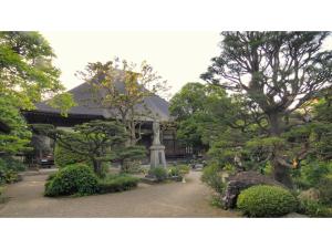 um jardim com árvores e arbustos em frente a um edifício em Hotel Tenryukaku - Vacation STAY 16416v em Fukushima