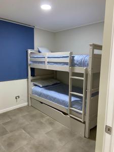 a room with three bunk beds in a room at Departamento Lagunamar Las Cruces in Las Cruces +3 photos