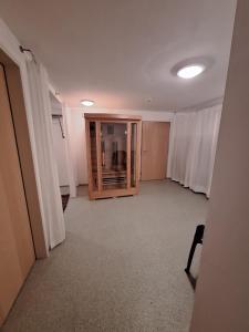 an empty room with white curtains and a hallway at Haus Obweg - Postalm in Hallein